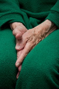 "Old woman's hands tucked between her legs", d'Horia Varlan